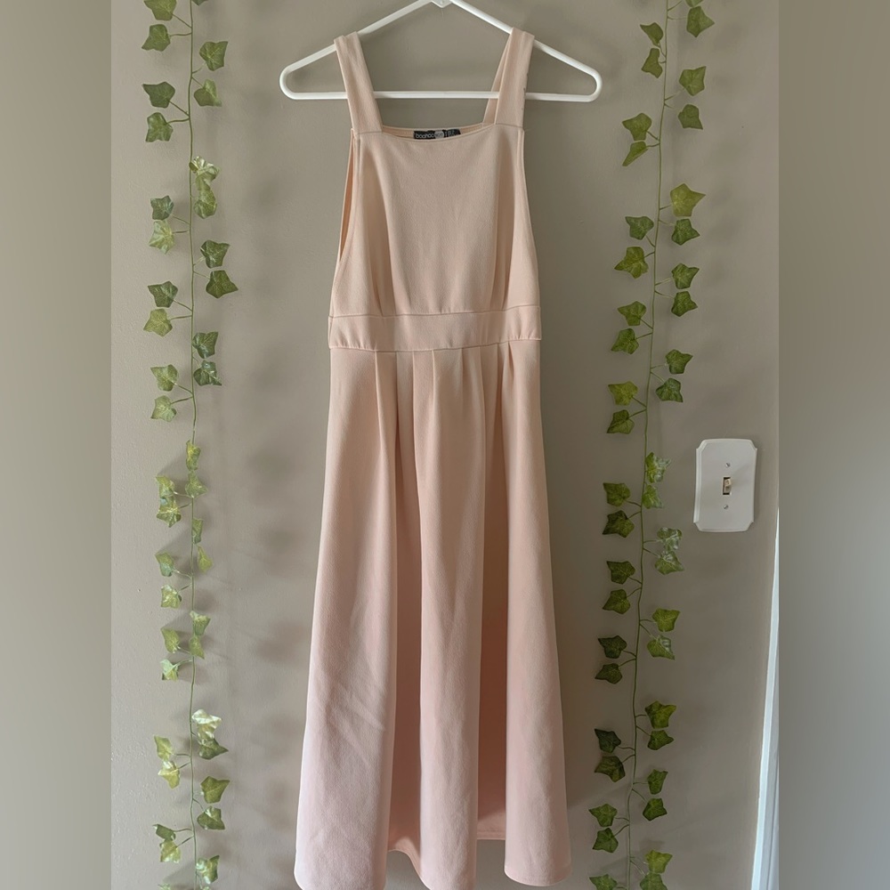 I am selling a light peach dress with straps.